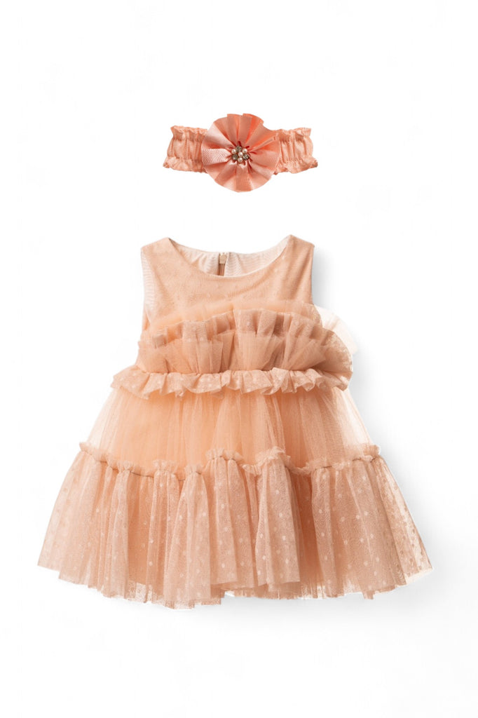 Baby girl peach tulle party dress with ruffles and polka dots, paired with a matching peach headband