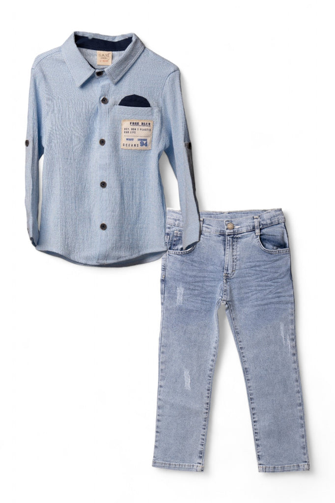 A stylish boy's outfit consisting of a blue shirt with rolled sleeves and a pair of light blue denim jeans.